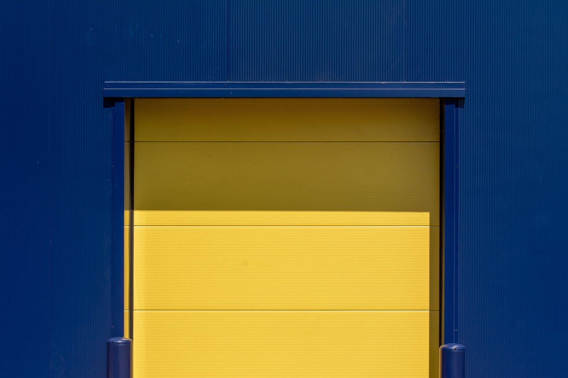 A closed roller shutter door set into a plain building wall