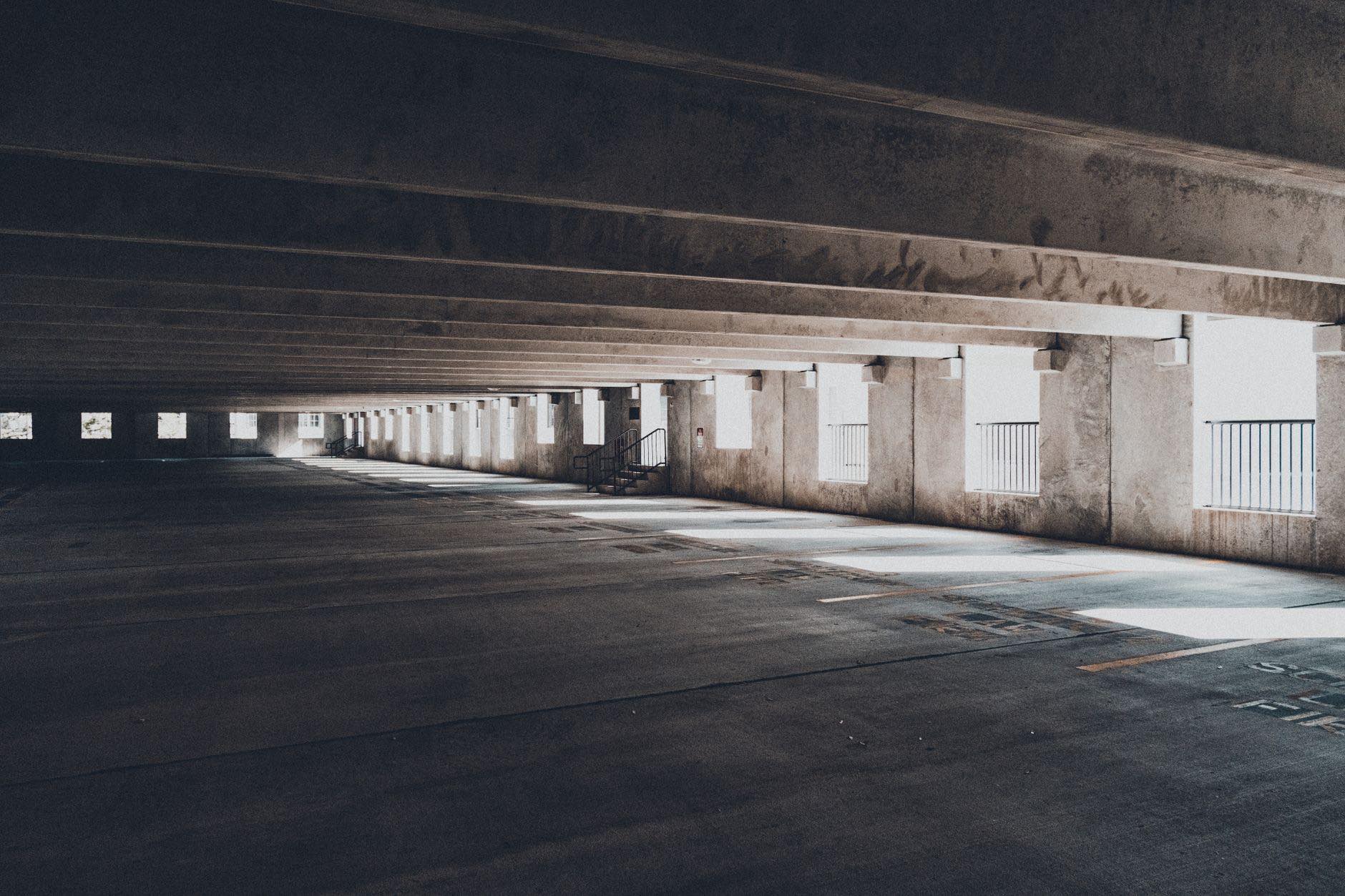 An empty parking deck with a lit lane running the length of the structure
