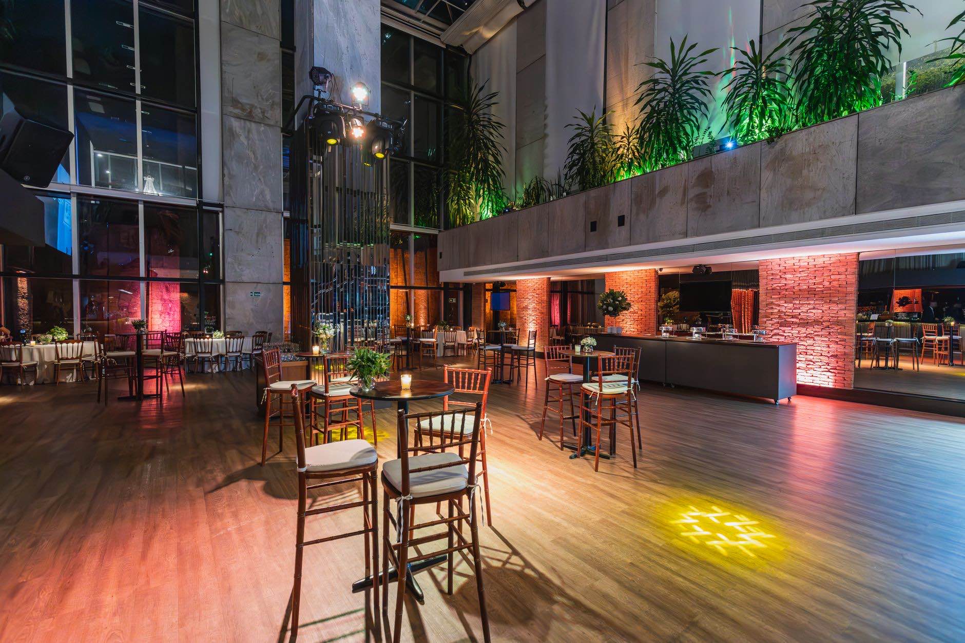 An empty bar and lounge interior with stools along the counter
